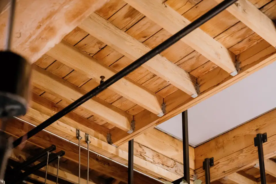 Round metal ducts along an exposed ceiling