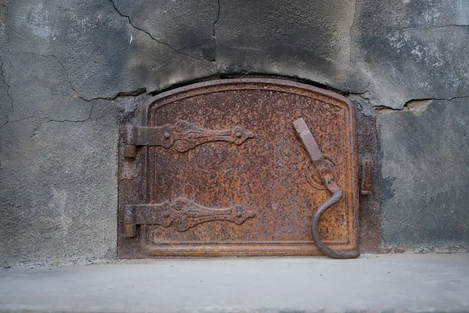Before: the door of an old rusted furnace